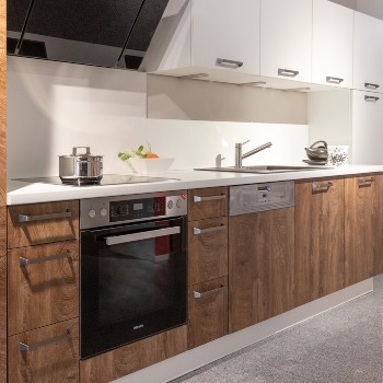 Moderne Küche mit weißen Hängeschränken und dunklen Holztüren